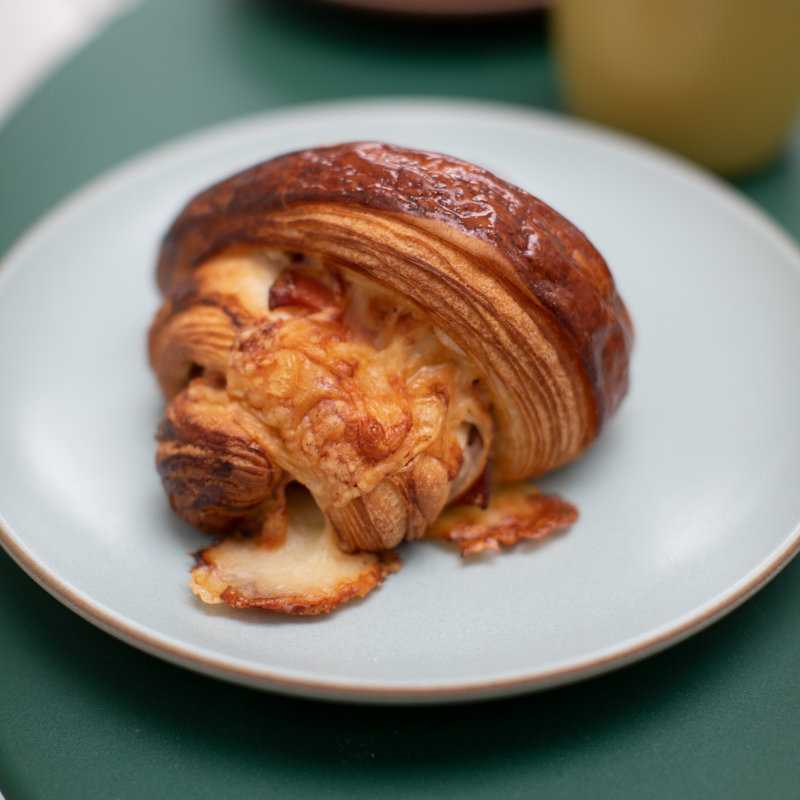 An irresistibly flaky pasty ready to be consumed by a customer